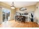 Bright dining area featuring hardwood floors, a chandelier, and sliding door access to the outdoor deck at 2835 S Jebel Way, Aurora, CO 80013