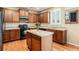 Kitchen featuring dark cabinets, black appliances, tiled countertops, and central island at 2835 S Jebel Way, Aurora, CO 80013