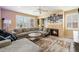 Relaxing living room featuring a corner fireplace and plush sectional at 2835 S Jebel Way, Aurora, CO 80013