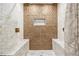 Close-up of shower featuring marble walls with geometric accent tiles and dual shower heads at 2835 S Jebel Way, Aurora, CO 80013