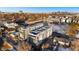 Aerial view of modern townhouses with city skyline in background at 1245 N Utica St # 103, Denver, CO 80204