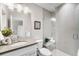 Clean bathroom with a walk-in shower and a gray tile design at 1245 N Utica St # 103, Denver, CO 80204