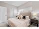 Bright bedroom with a queen-size bed and ensuite bathroom access at 1245 N Utica St # 103, Denver, CO 80204