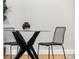 Minimalist dining set with glass top table and metal chairs at 1245 N Utica St # 103, Denver, CO 80204