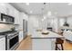 Modern kitchen with stainless steel appliances and an island at 1245 N Utica St # 103, Denver, CO 80204