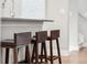 Three wooden stools at kitchen island at 1245 N Utica St # 103, Denver, CO 80204