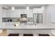 Modern kitchen with stainless steel appliances and an island at 1245 N Utica St # 103, Denver, CO 80204