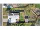 Aerial shot of a home featuring a spacious backyard with a patio, garden area, mature trees, and a privacy fence at 3035 E Maplewood Ave, Centennial, CO 80121