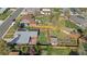 Aerial view showing a home with solar panels, a patio with seating, a large backyard, garden, shed, and a wooden fence at 3035 E Maplewood Ave, Centennial, CO 80121
