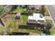Aerial view of a property with a large, fenced backyard, mature trees, and solar panels at 3035 E Maplewood Ave, Centennial, CO 80121