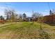 Large backyard with lush green grass, trees, a modern shed and a wood fence at 3035 E Maplewood Ave, Centennial, CO 80121