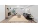 Basement living room featuring modern decor, exposed brick fireplace, and neutral colors at 3035 E Maplewood Ave, Centennial, CO 80121