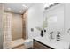 Modern bathroom features a stylish vanity, sleek fixtures, and a tiled shower at 3035 E Maplewood Ave, Centennial, CO 80121