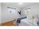 Cozy bedroom with hardwood floors, neutral paint, and warm natural light at 3035 E Maplewood Ave, Centennial, CO 80121