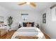Sunlit bedroom featuring hardwood floors, neutral tones, and large windows, creating a warm and inviting space at 3035 E Maplewood Ave, Centennial, CO 80121