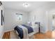 Comfortable bedroom with hardwood floors and bright natural light from the window at 3035 E Maplewood Ave, Centennial, CO 80121