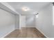 Neutral bedroom with wood floors, white walls, white trim, and a white door at 3035 E Maplewood Ave, Centennial, CO 80121