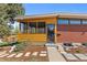 Charming single story home with a brick facade, wood accents, a screened porch, and a well-maintained front yard at 3035 E Maplewood Ave, Centennial, CO 80121