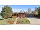 Charming brick home with a well-manicured front yard, mature trees, and a two-car garage at 3035 E Maplewood Ave, Centennial, CO 80121