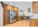 Bright kitchen features stainless appliances, wood cabinets, and white countertops, offering a modern and stylish cooking space at 3035 E Maplewood Ave, Centennial, CO 80121