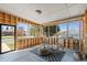 Bright sunroom with wood paneling, large windows offering outdoor views, and a cozy seating area with rocking chairs at 3035 E Maplewood Ave, Centennial, CO 80121