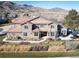 Stunning aerial view of a beautiful home, professional landscaping, and mountain views at 16226 River Haven Way, Morrison, CO 80465