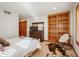 Bedroom featuring a bed, dresser with TV, bookcase, and decorative cowhide rug at 16226 River Haven Way, Morrison, CO 80465