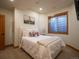 Basement bedroom with neutral colored walls and carpet with a window at 16226 River Haven Way, Morrison, CO 80465