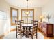 Charming dining room with a round wooden table, natural light, and stylish decor at 16226 River Haven Way, Morrison, CO 80465