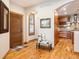 Inviting entryway with wood floors, bench seating, and views into the kitchen area at 16226 River Haven Way, Morrison, CO 80465