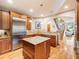 Spacious kitchen featuring a center island, stainless steel refrigerator, and access to the staircase at 16226 River Haven Way, Morrison, CO 80465