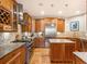 Well-lit kitchen with wooden cabinets, stainless steel appliances, and granite countertops at 16226 River Haven Way, Morrison, CO 80465