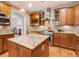 Bright kitchen with an island, wooden cabinets, and stainless steel range at 16226 River Haven Way, Morrison, CO 80465