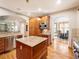 Gourmet kitchen featuring custom wood cabinetry, granite countertops, and stainless steel appliances, flowing into the dining area at 16226 River Haven Way, Morrison, CO 80465