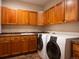 Spacious laundry room featuring ample cabinet space, solid surface countertops and modern washer and dryer at 16226 River Haven Way, Morrison, CO 80465