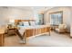 Serene main bedroom featuring a wood bed, sitting area, and dual windows at 16226 River Haven Way, Morrison, CO 80465