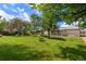 Expansive backyard features a well-maintained lawn and mature trees at 13010 W 6Th Pl, Golden, CO 80401