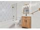 Stylish bathroom featuring patterned wall tiles, vanity, and bathtub at 13010 W 6Th Pl, Golden, CO 80401