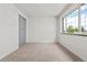 Bright bedroom featuring a large window, closet, and carpeted floors at 13010 W 6Th Pl, Golden, CO 80401