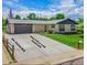 Exterior shot highlighting the long driveway with ample parking, attached garage, and well-kept front yard at 13010 W 6Th Pl, Golden, CO 80401