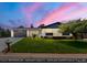 Charming exterior showcasing the well-manicured lawn and attached garage, enhanced by a beautiful twilight sky at 13010 W 6Th Pl, Golden, CO 80401