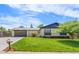 Well-maintained exterior with lush green lawn, attached garage, and lovely curb appeal under a bright sky at 13010 W 6Th Pl, Golden, CO 80401