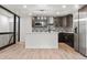 Modern kitchen featuring new appliances, an island with bar seating, and stylish cabinetry with light floors at 13010 W 6Th Pl, Golden, CO 80401