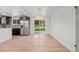 Bright open kitchen area with stainless steel fridge and sliding glass doors leading to outdoor space at 13010 W 6Th Pl, Golden, CO 80401
