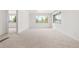 Bright living room featuring large windows, carpeted floors, and neutral walls at 13010 W 6Th Pl, Golden, CO 80401