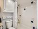 Clean bathroom with white tiles, overhead cabinet, and shower-tub combination at 962 S Dearborn Way # 19, Aurora, CO 80012