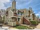 Charming condo exterior featuring a well-maintained lawn, red stairs, and olive green siding under a bright sky at 962 S Dearborn Way # 19, Aurora, CO 80012