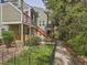 Condo with red stair railings, lush landscaping, and brick accents on a peaceful, tree-lined path at 962 S Dearborn Way # 19, Aurora, CO 80012