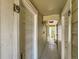 Hallway featuring doors with numbers 19 and 16 with olive green wood paneling and view of the outdoors at 962 S Dearborn Way # 19, Aurora, CO 80012