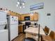 Kitchen with oak cabinets, modern appliances, and a breakfast bar with seating under a modern light fixture at 962 S Dearborn Way # 19, Aurora, CO 80012
